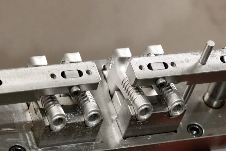 pecialized CNC machining jig securing aluminum die cast enclosures for high-accuracy 4th axis milling operations.