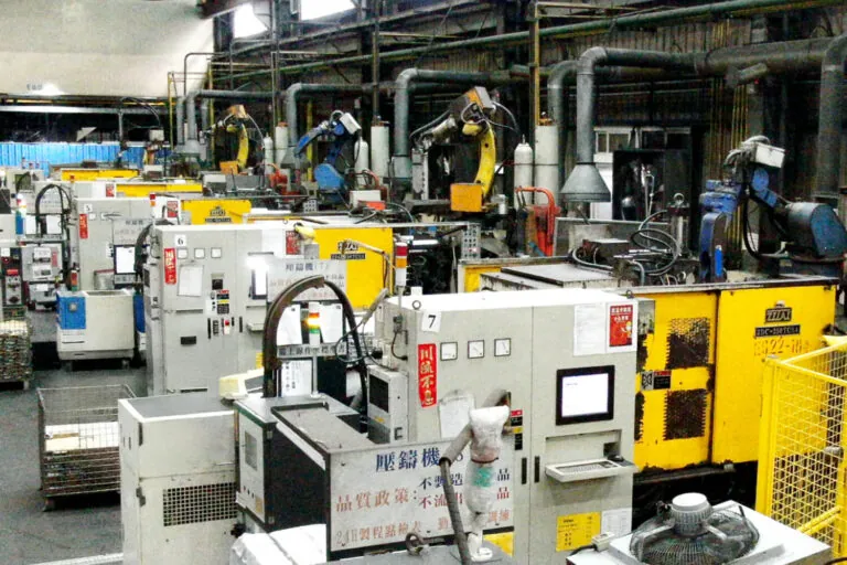 Large-scale aluminum die casting facility in Taiwan featuring a row of cold chamber machines for high-volume OEM component production.