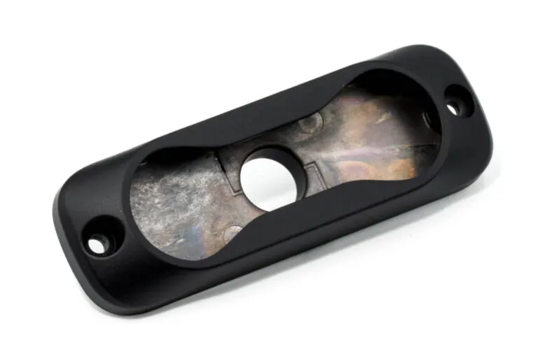 Anodized black aluminum die cast light fixture bezel creating a hard, wear-resistant surface for high-friction industrial lighting applications