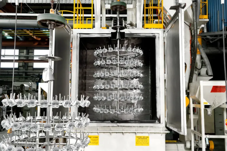 Precision-engineered aluminum die cast LED heat sinks arranged for automated Shot Blasting to ensure optimal thermal dissipation for high-power lighting fixtures.