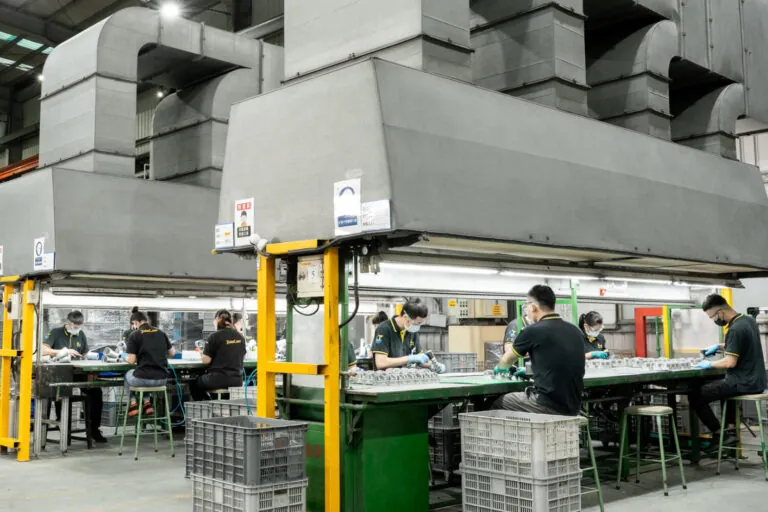 A dedicated 170-person manufacturing team performing quality inspection and precision assembly within a vertically integrated production facility.