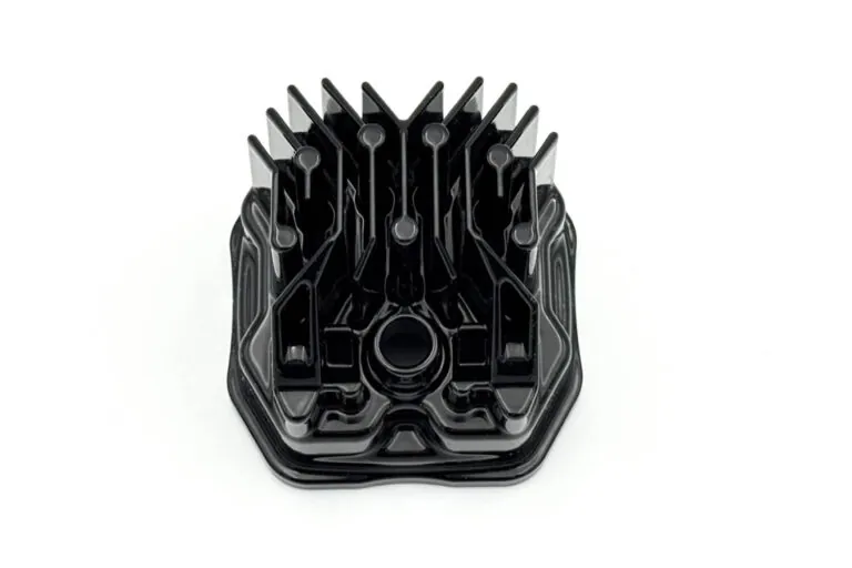 Detailed view of a black finished aluminum die casting with integrated cooling fins designed for high-performance thermal management.