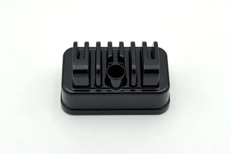 Detailed view of a black finished aluminum die casting with integrated cooling fins designed for high-performance thermal management.