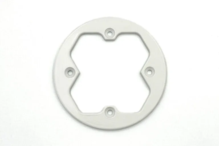 Close-up of a white powder-coated aluminum die-cast frame illustrating uniform coating thickness and clean edge definition.