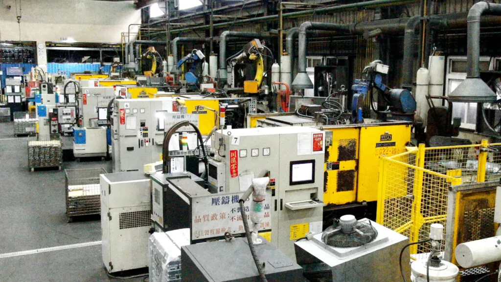 Large-scale aluminum die casting facility in Taiwan featuring a row of cold chamber machines for high-volume OEM component production.